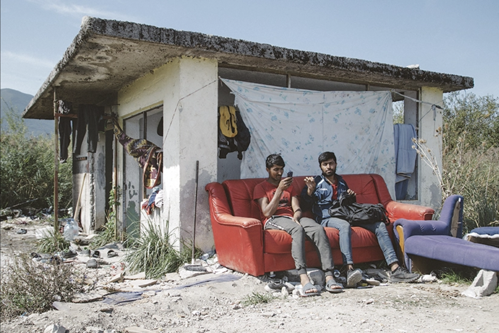 Nearly a year after the fire at Europe’s doorstep, conditions remain miserable for refugees