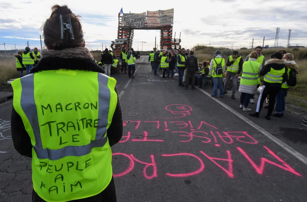 Macron bows to yellow vests, pleasing no one