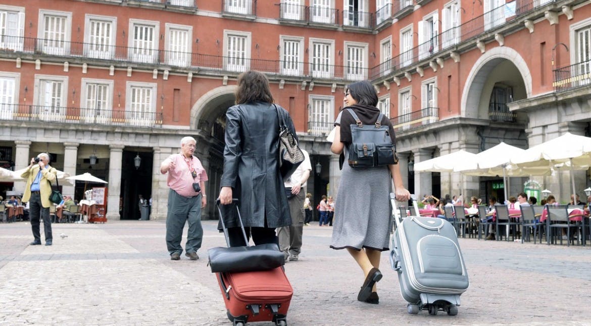 In Madrid, there’s an invasion – of rolling suitcases